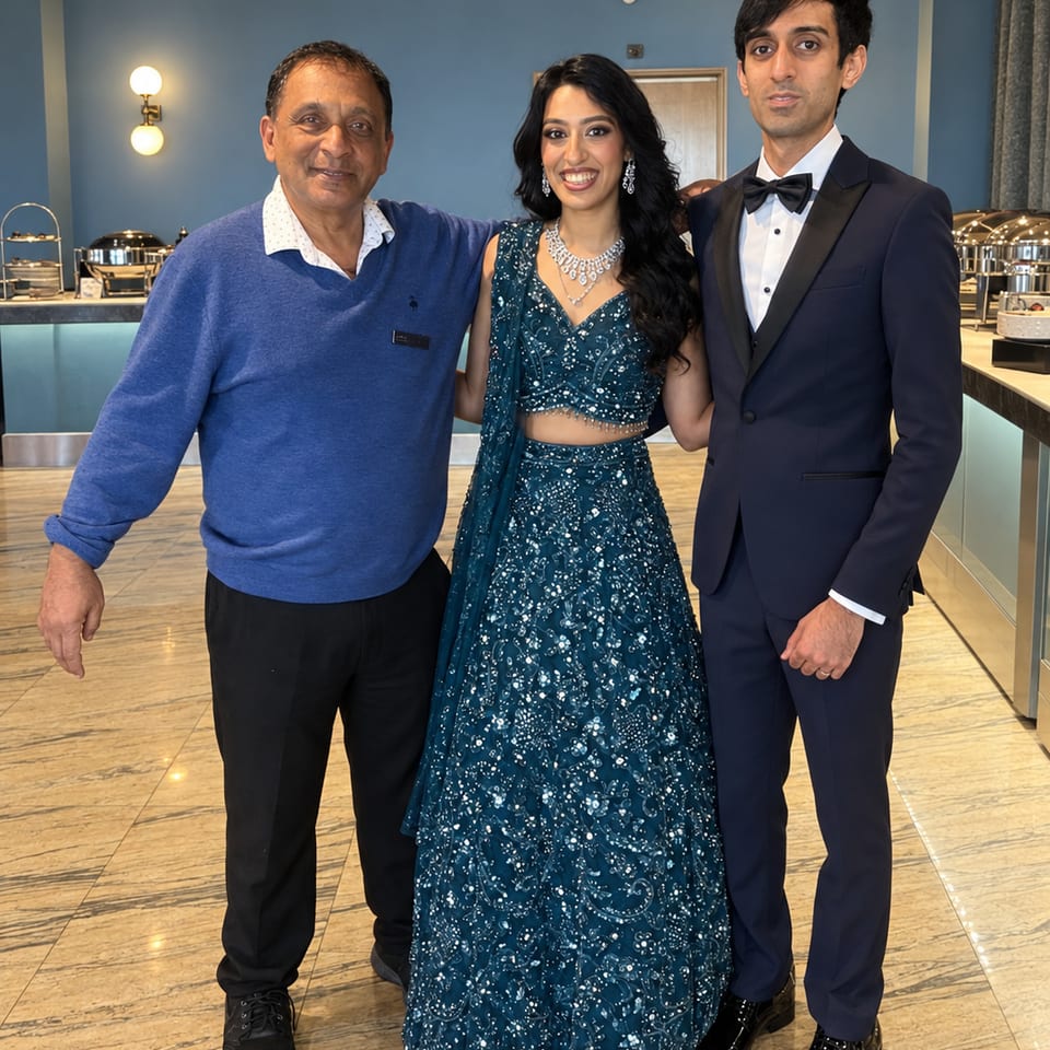 Three guests at a reception beside a buffet