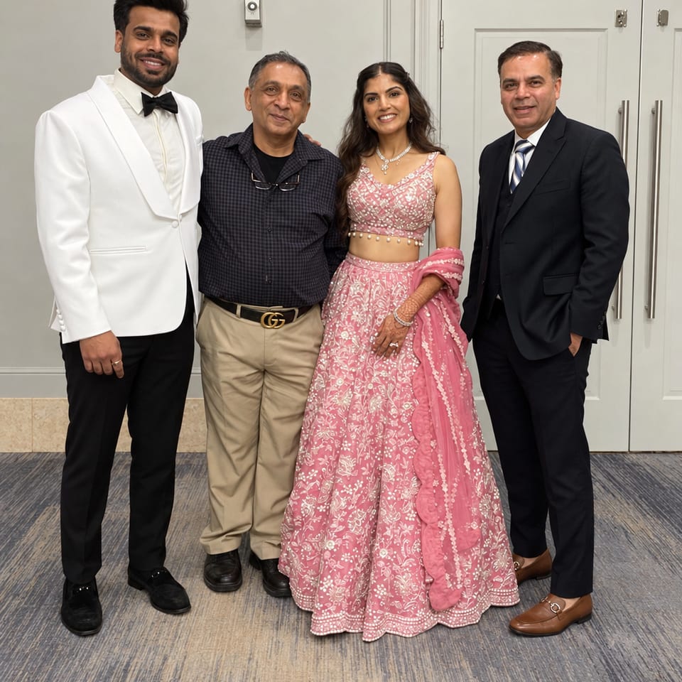 Four guests posing at a wedding reception