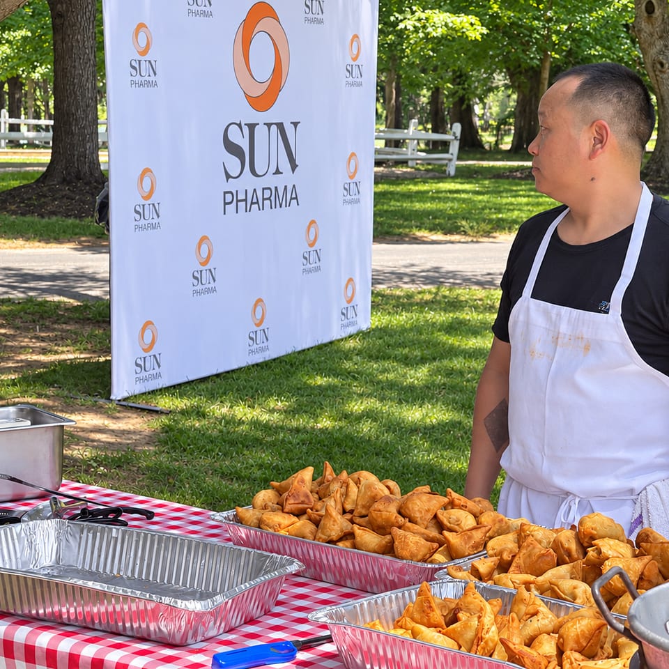 Samosas served at an outdoor catering station