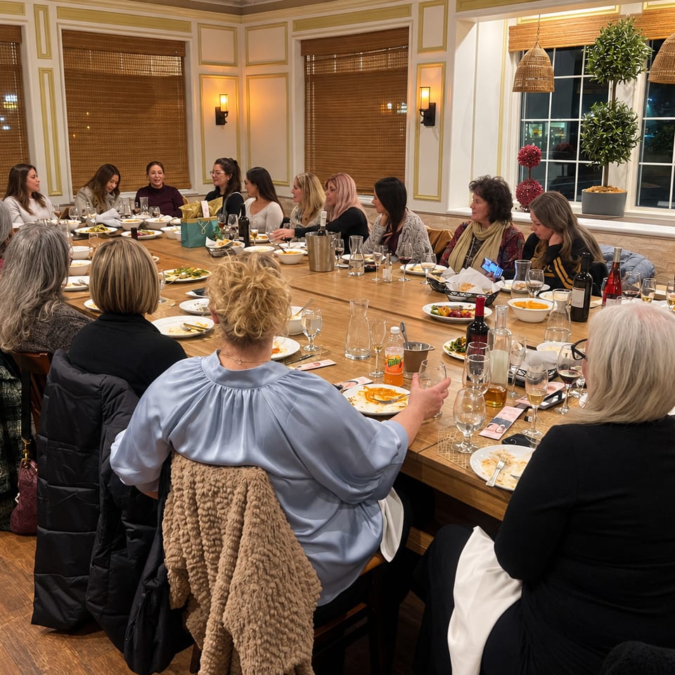 Guests sharing a meal around a long dining table