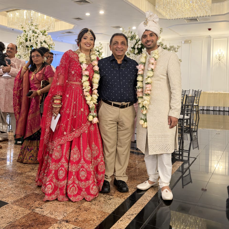 Wedding guests posing in a decorated ballroom