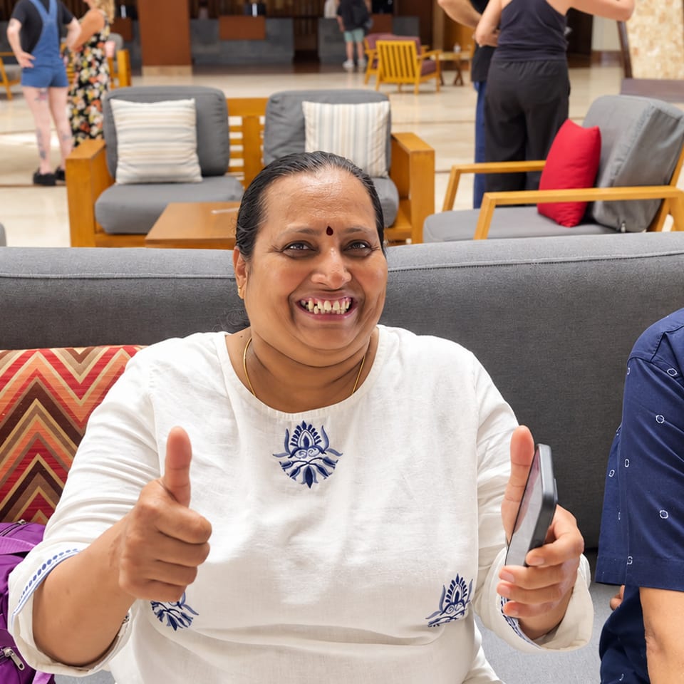 Smiling guests seated together in a lounge
