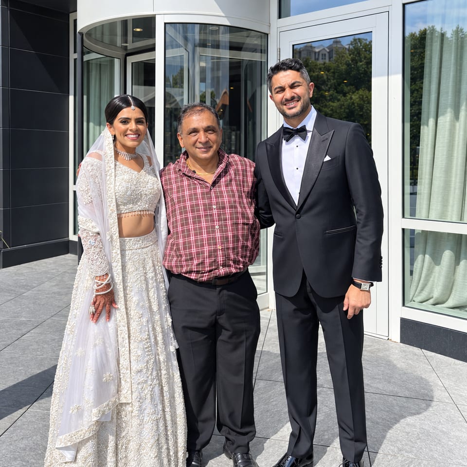 Three wedding guests outside a glass-fronted venue