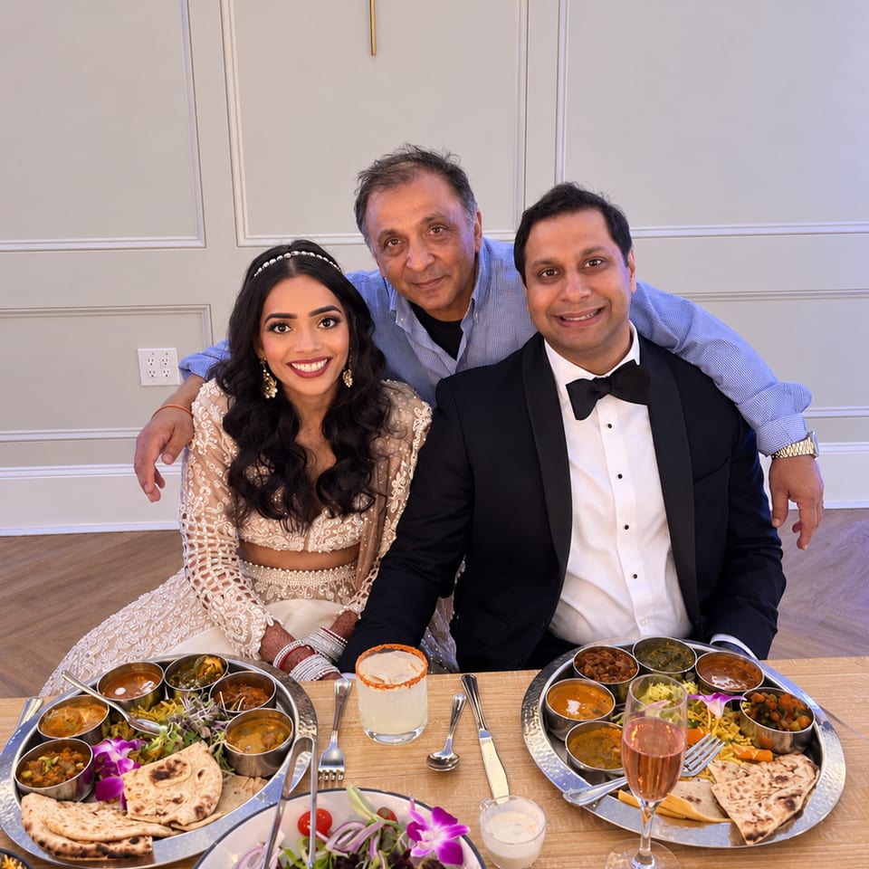 Wedding guests seated with thali platters