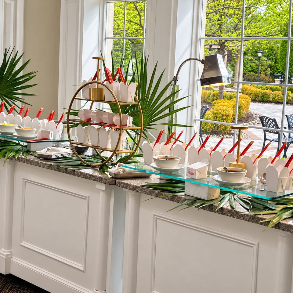 Catering station with white cartons and red chopsticks